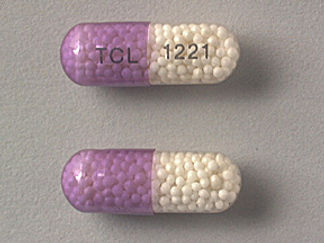 This is a Capsule Er imprinted with TCL on the front, 1221 on the back.