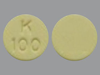 This is a Tablet imprinted with K  100 on the front, nothing on the back.