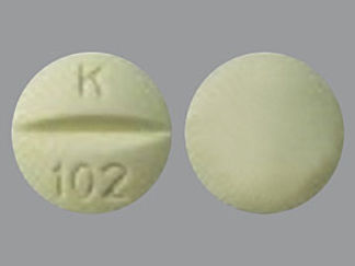This is a Tablet imprinted with K  102 on the front, nothing on the back.