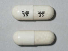 This is a white oblong Capsule Dr imprinted with OME  20 on the front, OME  20 on the back, and is manufactured by SANDOZ.