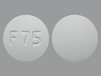 Esto es un Tableta imprimido con F 75 en la parte delantera, nada en la parte posterior, y es fabricado por None.