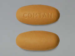 This is a brownish-orange oval Tablet imprinted with COMTAN on the front, nothing on the back, and is manufactured by SANDOZ.