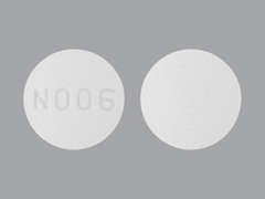 This is a Tablet imprinted with N006 on the front, nothing on the back.