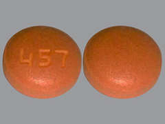 This is a brownish-red round Tablet imprinted with 457 on the front, nothing on the back, and is manufactured by ALEMBIC PHARMAC.