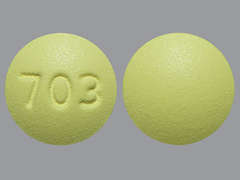 Esto es un Tableta amarillo redondo imprimido con 703 en la parte delantera, nada en la parte posterior, y es fabricado por NATIONWIDE LABO.