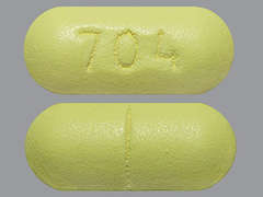 Esto es un Tableta amarillo oblongo imprimido con 704 en la parte delantera, nada en la parte posterior, y es fabricado por NATIONWIDE LABO.