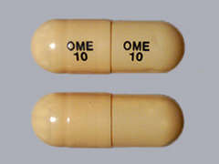 This is a brown oblong Capsule Dr imprinted with OME  10 on the front, OME  10 on the back, and is manufactured by SANDOZ.