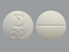 Esto es un Tableta blanco redondo imprimido con logo and 20 en la parte delantera, nada en la parte posterior, y es fabricado por SIGMAPHARM LABO.