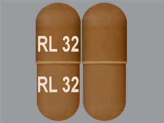 Esto es un Cápsula imprimido con RL 32 en la parte delantera, RL 32 en la parte posterior, y es fabricado por None.