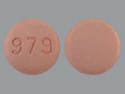 Zolmitriptan: This is a pink round Tablet imprinted with 979 on the front, nothing on the back, and is manufactured by SUN PHARMA GLOB.