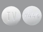 Fluvastatin Er: This is a Tablet Er 24 Hr imprinted with TV on the front, 7446 on the back.