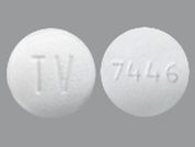 Fluvastatin Er: Esto es un Tableta Er 24 Hr imprimido con TV en la parte delantera, 7446 en la parte posterior, y es fabricado por None.