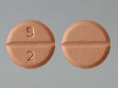 This is a peach round Tablet imprinted with 9  2 on the front, nothing on the back, and is manufactured by TORRENT PHARMAC.