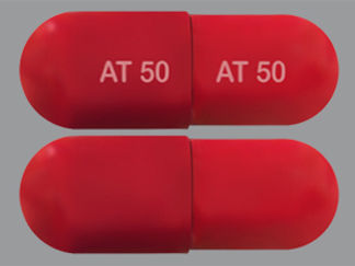 This is a Capsule imprinted with AT 50 on the front, AT 50 on the back.