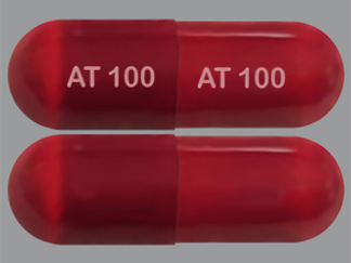 This is a Capsule imprinted with AT 100 on the front, AT 100 on the back.