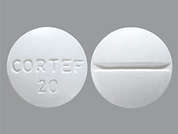 Cortef: Esto es un Tableta blanco redondo imprimido con CORTEF  20 en la parte delantera, nada en la parte posterior, y es fabricado por PHARMACIA-UPJHN.