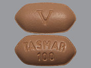 Tasmar: Esto es un Tableta imprimido con V en la parte delantera, TASMAR  100 en la parte posterior, y es fabricado por None.