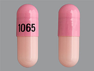 This is a Capsule imprinted with 1065 on the front, nothing on the back.