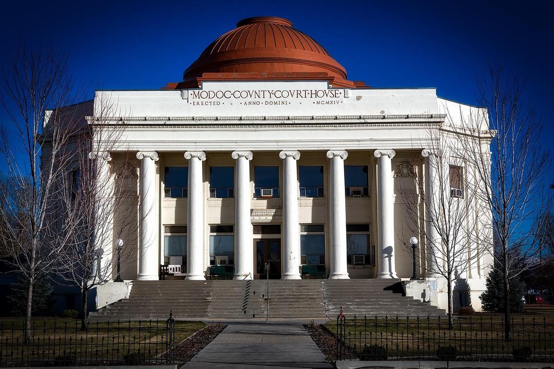 File image: White neoclassical courthouse building with copper dome, columns, and grand entrance.