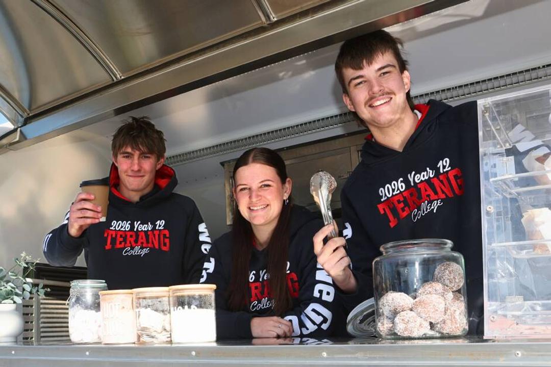 Three Year 12 Terang College students display trophy and jars of homemade goods