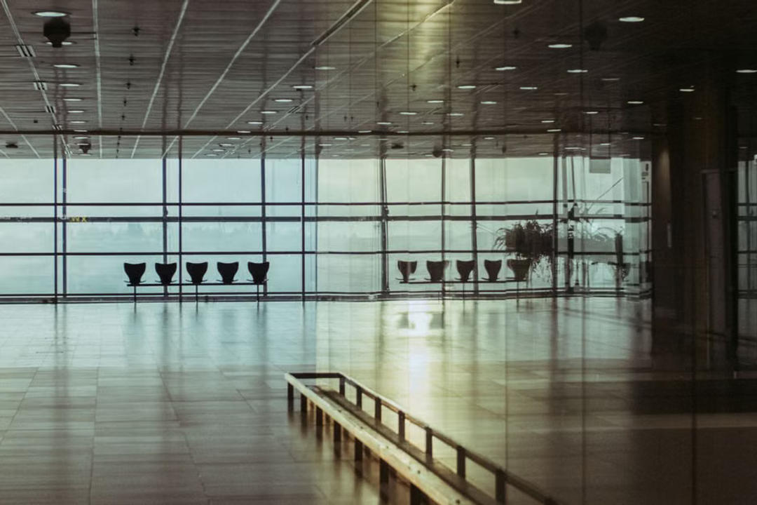 File image: Empty airport terminal with rows of chairs and large windows
