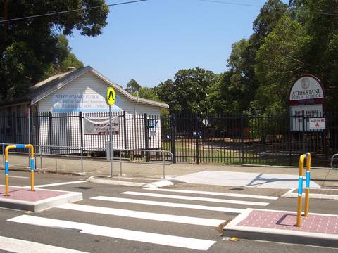 Athelstane Public School entrance gate with pedestrian crossing markings on Australian suburban street