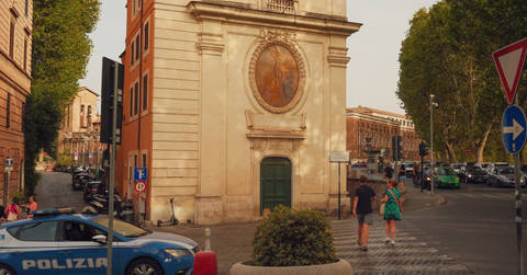 File image: Italian police car on Rome street with historic church building and European architecture.
