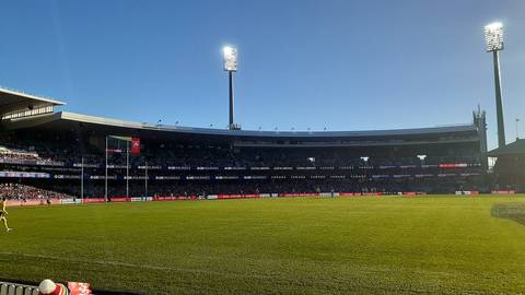File image: Australian rules football stadium with empty oval, floodlights, and crowd seating