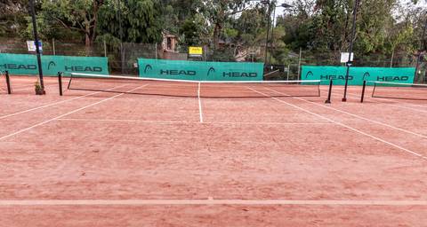 File image: Empty clay tennis court with HEAD sponsor boards