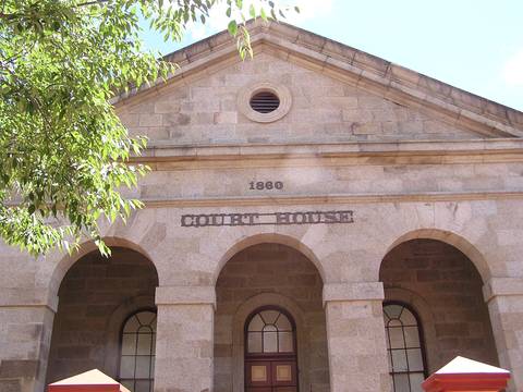 File image: Stone courthouse exterior with 1880 date and arched entrances