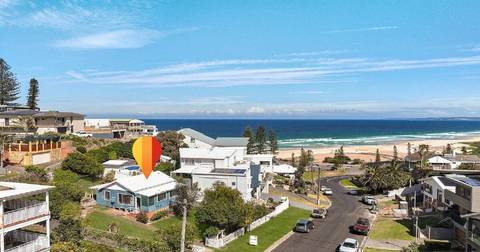 Aerial view of beachfront homes in Redhead with ocean and beach visible