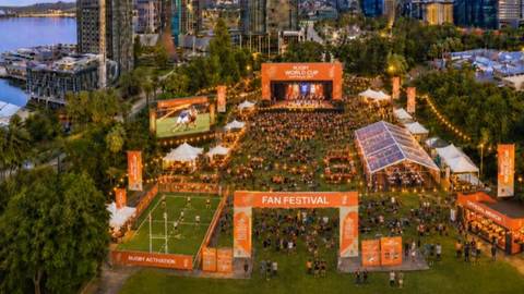 Aerial photograph of Perth rugby world cup fan festival with stage, crowd, tents and city skyline