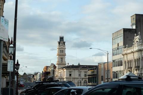 File image: Victorian-era city street with ornate tower and parked cars