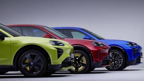 Three Porsche Cayenne electric vehicles in lime, red, and blue parked side-by-side in studio setting.