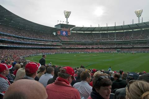 File image: Large AFL stadium interior packed with spectators wearing team colors during a finals match