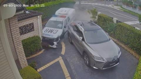 Security camera footage of police car positioned against brick house with Lexus parked nearby