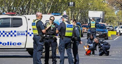 Australian police officers with marked van at public event