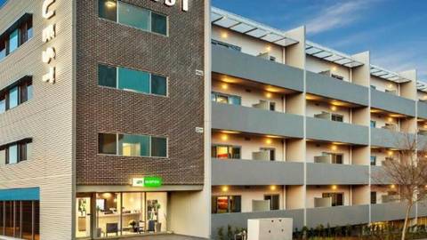 Contemporary mixed-use apartment hotel complex with ground floor retail