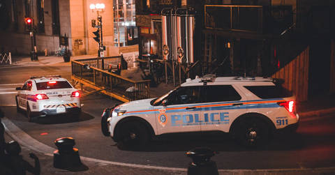 File image: Police patrol vehicles parked on an urban street at night
