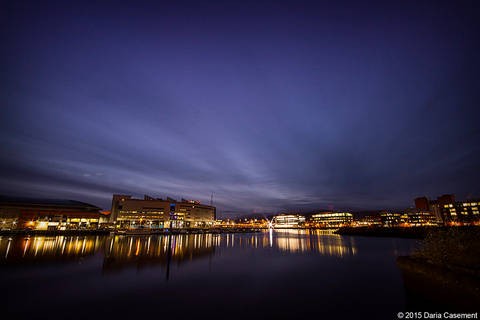 File image: Nighttime city waterfront with lit buildings reflected in calm water