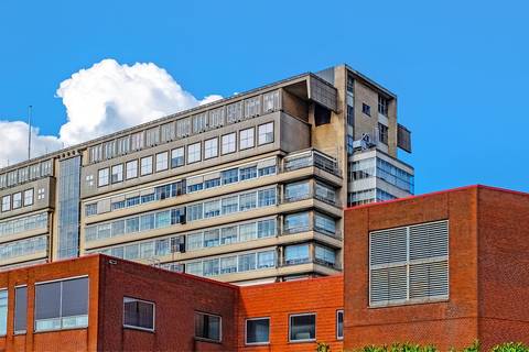 File image: Large concrete multi-storey building behind red brick foreground structures
