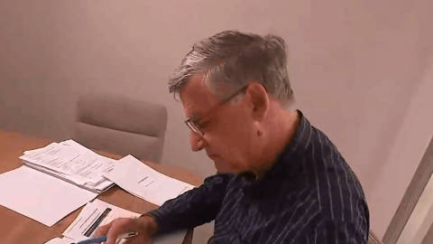 Man reviewing documents at desk in office setting