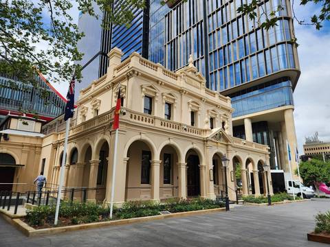 File image: Heritage classical building with columns at street level, surrounded by modern structures