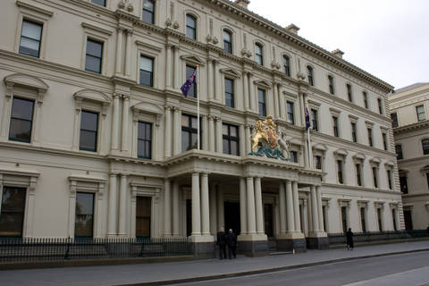 File image: Neoclassical government building with columns, coat of arms, and Australian flags