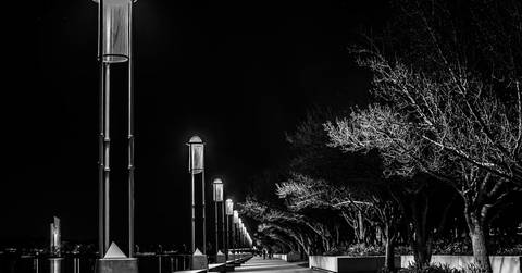 File image: Night-time waterfront promenade lined with street lamps and bare trees