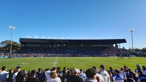 File image: Packed rugby league stadium grandstand under clear blue sky