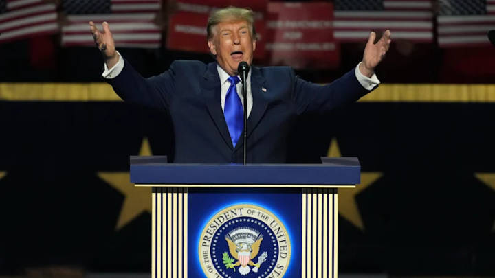 Donald Trump. Person speaking at presidential podium with American flags in background