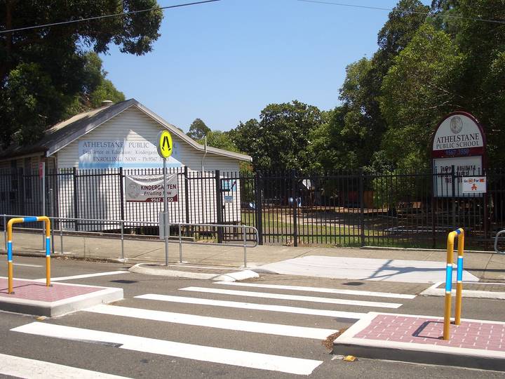 Athelstane Public School entrance gate with pedestrian crossing markings on Australian suburban street