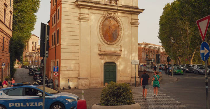 File image: Italian police car on Rome street with historic church building and European architecture.