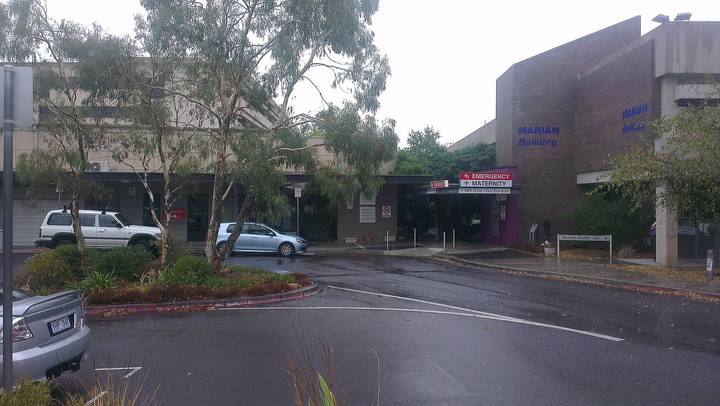 File image: Street view of Marian medical facility building with parked vehicles and trees